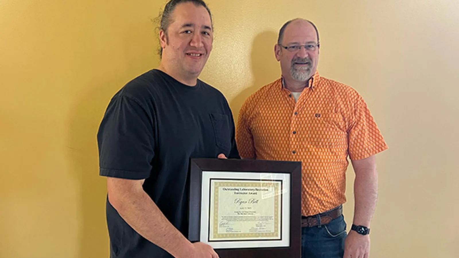 Ryan Bell congratulated by Interim Director Harold Fisk