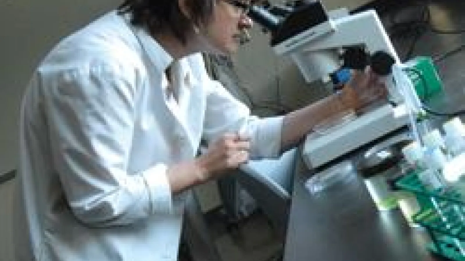 Researcher looking through a microscope 