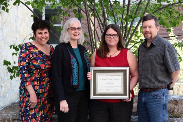 Corrie Pieterson receiving the TA award from Dr. Caroline Breitenberger, director, and assistant directors, Dr. Judy Ridgway and Matt Misicka